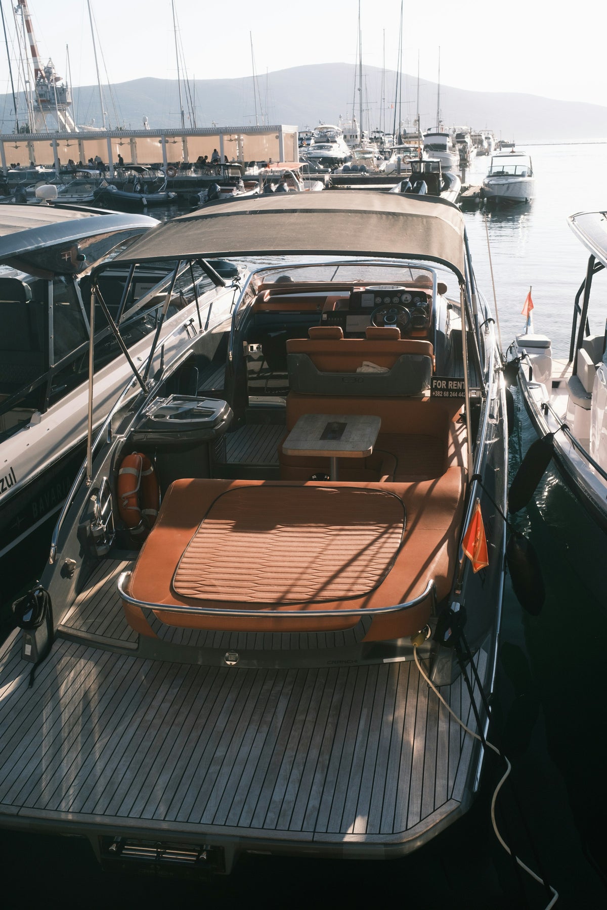 Luxury yacht docked in a marina at sunset